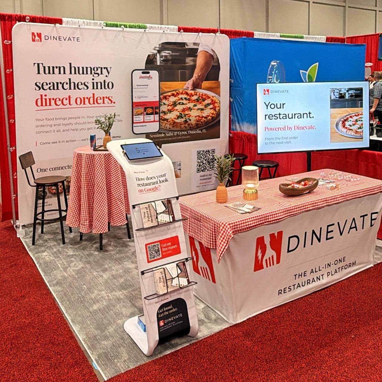 The Dinevate booth with a restaurant website demo, ordering kiosk and red gingham tables